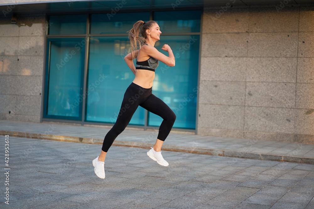 Woman running urban city street background Woman running urban city street background