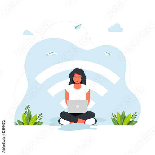 free wifi zone. Public free wifi hotspot zone wireless connection, business concept. woman sitting in lotus position working at a laptop against the background of a large wi-fi icon. freelance concept