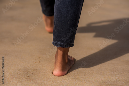 Cropped shot of womans feet walking along coast © rushay