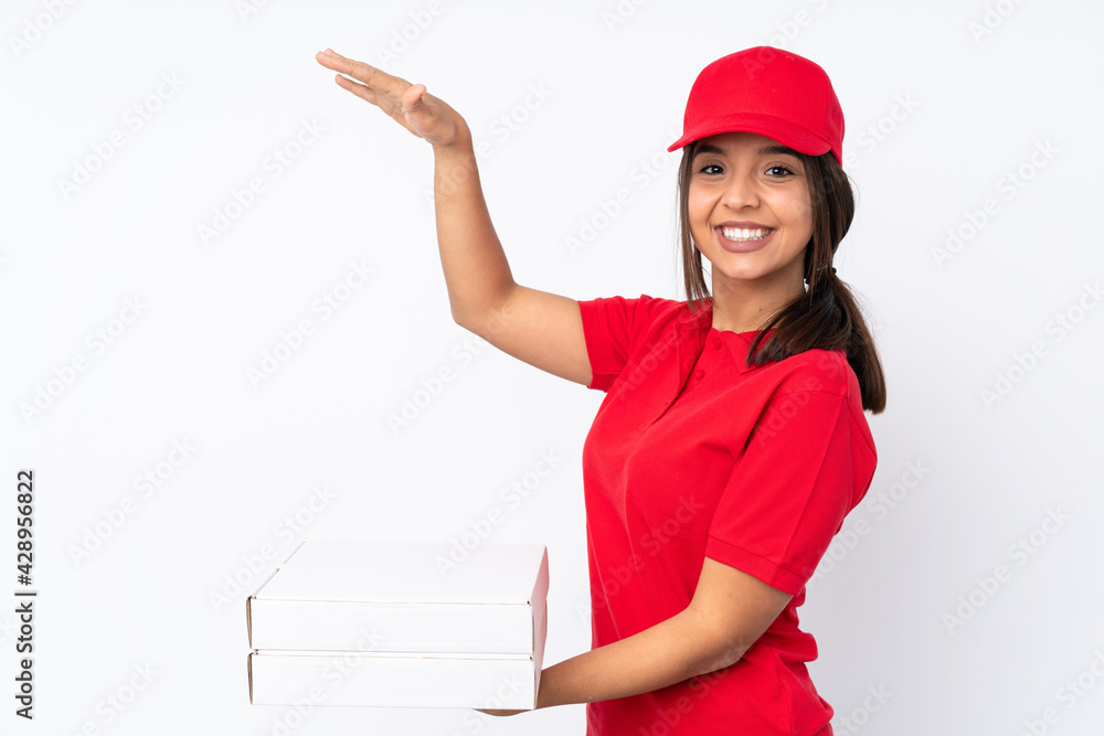 Young Pizza delivery girl over isolated white background holding copyspace to insert an ad Young Pizza delivery girl over isolated white background holding copyspace to insert an ad