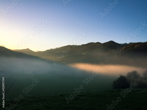 Early foggy morning in mountains village, natural colors of nature, valley in mountains