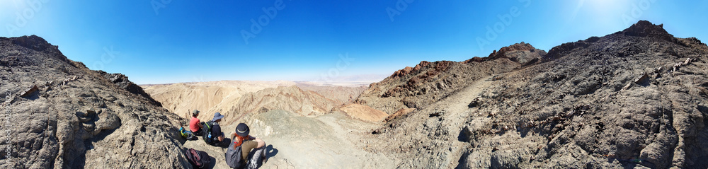 hiking trail in Eilat mountains. Red rock formations and boulders. Panoramic view over the trail on surrounding red mountains. Eilat, Israel Israel, Eilat Mountains: Red Canyon hiking trail in Eilat mountains. Red rock formations and boulders. Panoramic view over the trail on surrounding red mountains. Eilat, Israel Israel, Eilat Mountains: Red Canyon