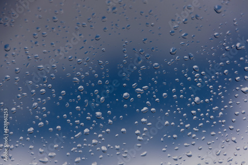 Background. Water drops on the glass, window. Blue sky