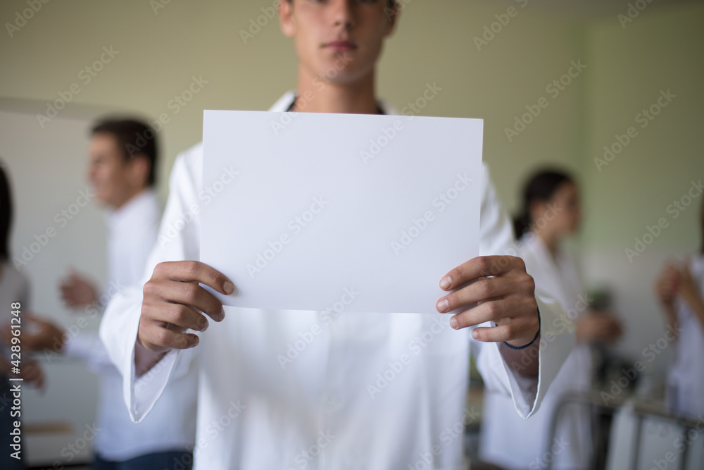Medical students in patient's hospital room. Portrait of young student. Focus is on foreground. Space for copy. Medical students in patient's hospital room. Portrait of young student. Focus is on foreground. Space for copy.