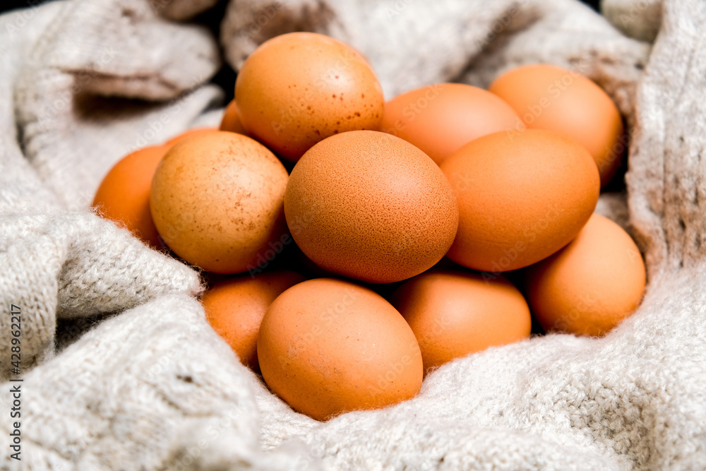 Natural brown eggs. Natural egg on a knitted mat. Ecostyle. Natural brown eggs. Natural egg on a knitted mat. Ecostyle.