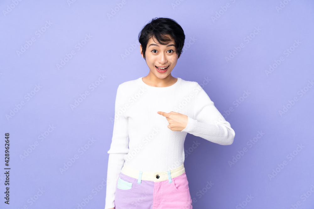 Young Vietnamese woman with short hair over isolated purple background with surprise facial expression Young Vietnamese woman with short hair over isolated purple background with surprise facial expression