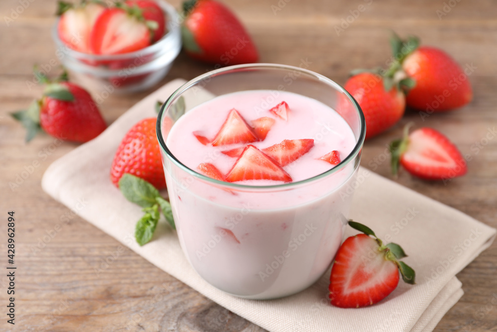 Delicious drink with strawberries on wooden table Delicious drink with strawberries on wooden table