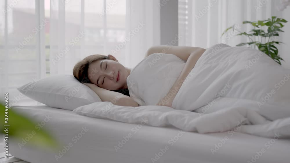 Asian women sleeping and sweet dream on white bed in bedroom Asian women sleeping and sweet dream on white bed in bedroom