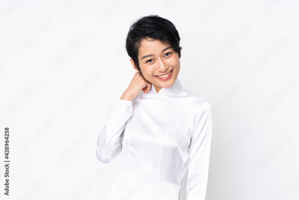 Young Vietnamese woman with short hair wearing a traditional dress over isolated white background laughing Young Vietnamese woman with short hair wearing a traditional dress over isolated white background laughing