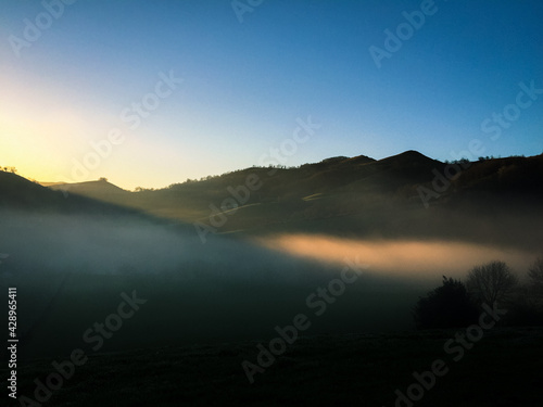 Early foggy morning in mountains village, natural colors of nature, valley in mountains
