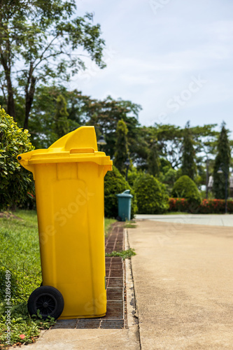 Yellow plastic bins located in the park.