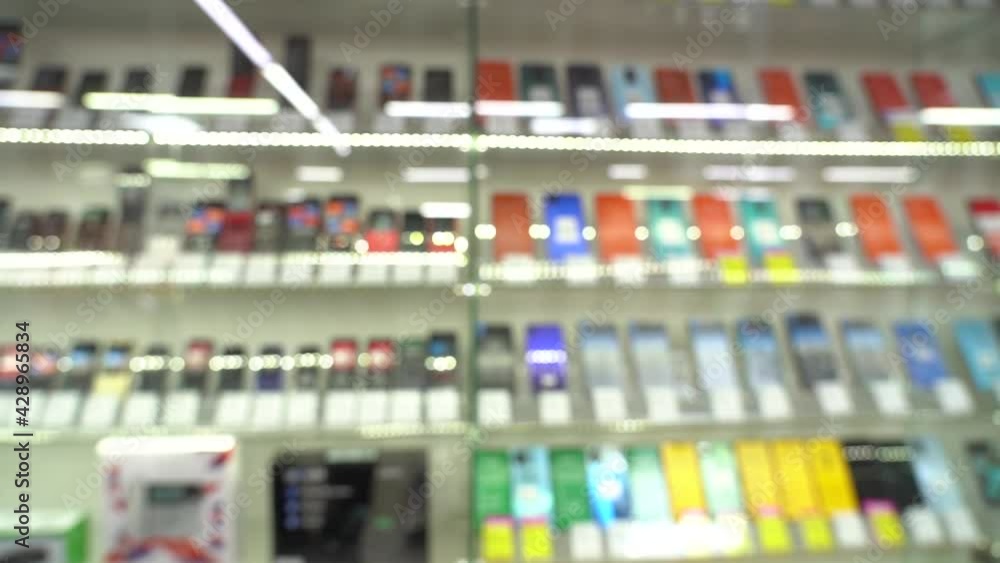 Shelf with new smartphones in a hardware store. Close-up. PAN. blurred video Shelf with new smartphones in a hardware store. Close-up. PAN. blurred video