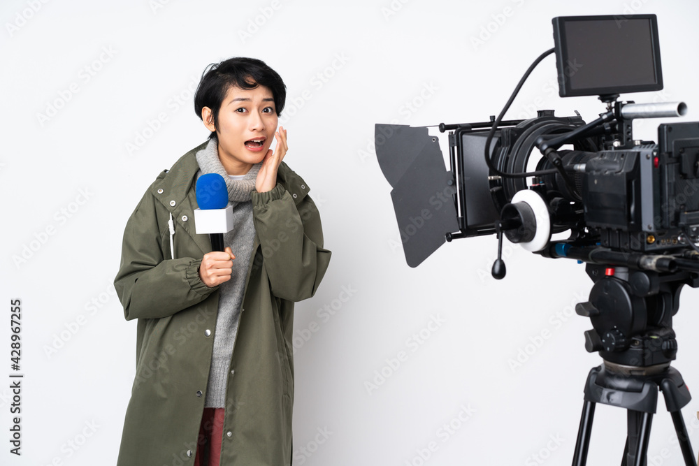 Reporter Vietnamese woman holding a microphone and reporting news with surprise and shocked facial expression