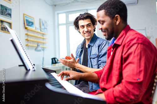 teacher practicing vocal cords with man in class day time