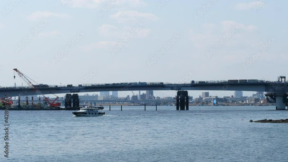 View Of Daishi Bridge Across Tama River From Haneda Airport In Ota City, Tokyo. wide shot, static View Of Daishi Bridge Across Tama River From Haneda Airport In Ota City, Tokyo. wide shot, static