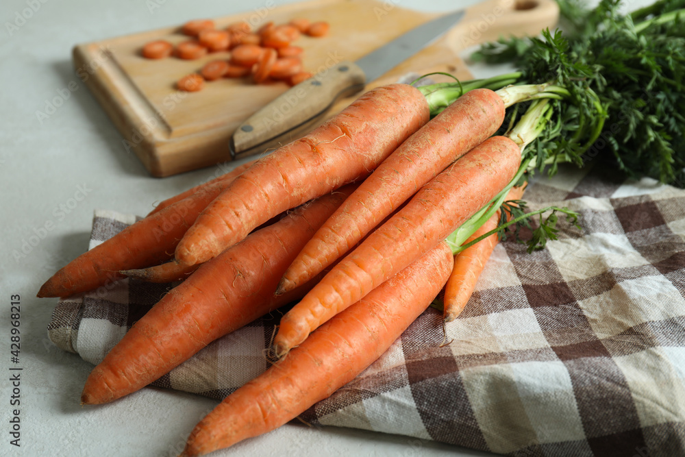 Concept of fresh vegetable with carrot on white textured table Concept of fresh vegetable with carrot on white textured table