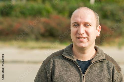 Natural looking guy with blue eyes smiling, portrait 