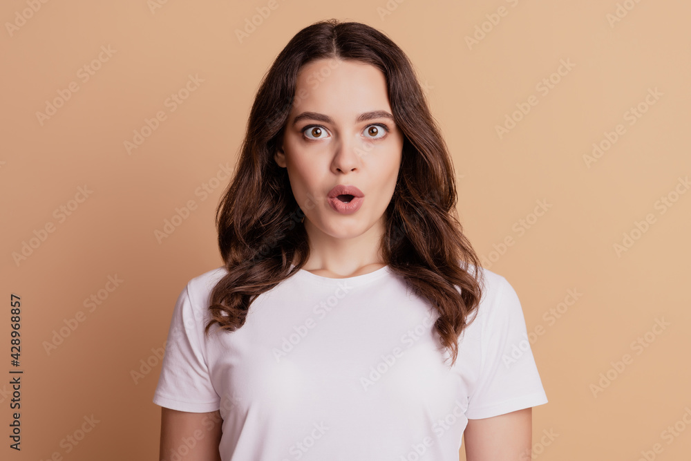Portrait of shocked crazy lovely girl open mouth isolated on beige background Portrait of shocked crazy lovely girl open mouth isolated on beige background