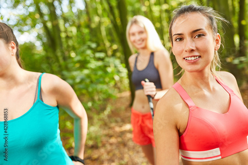 Sporty young woman doing nordic walking