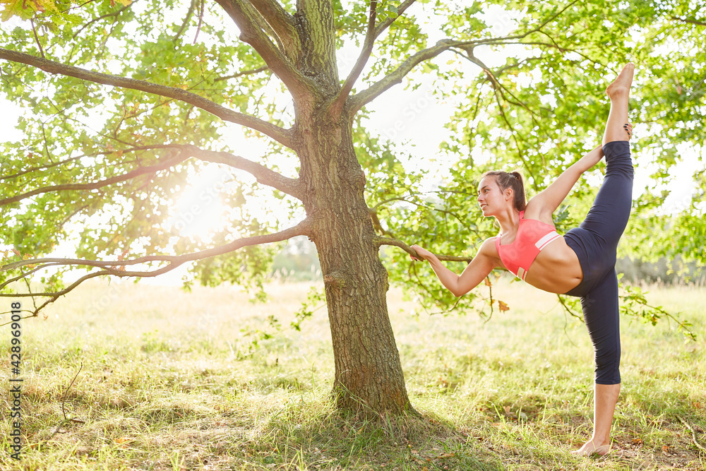 Sporty woman does a healthy stretching exercise