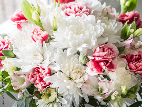 Bouquet close-up. Bouquet of white chrysanthemums  red carnations and eucalyptus leaves
