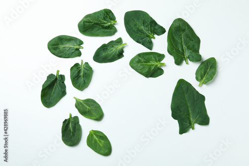 Fresh raw spinach leaves on white background