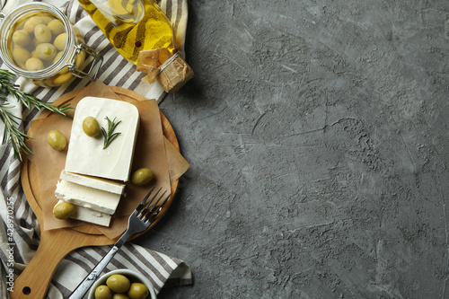 Concept of tasty food with feta cheese on gray textured background