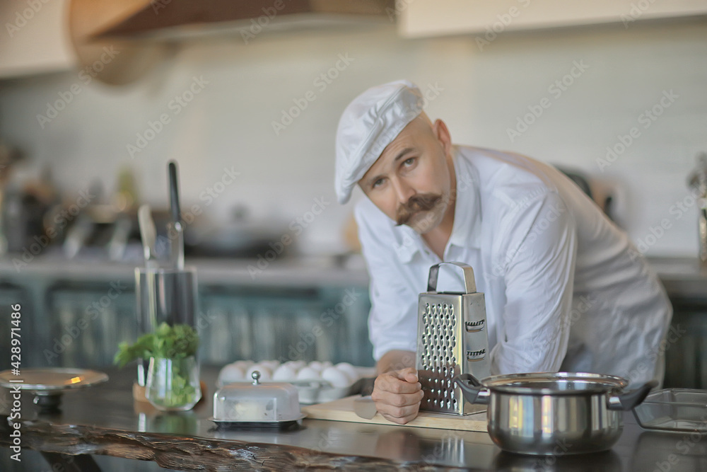 french chef in the kitchen preparing food, cooking, haute cuisine, man with mustache french chef in the kitchen preparing food, cooking, haute cuisine, man with mustache