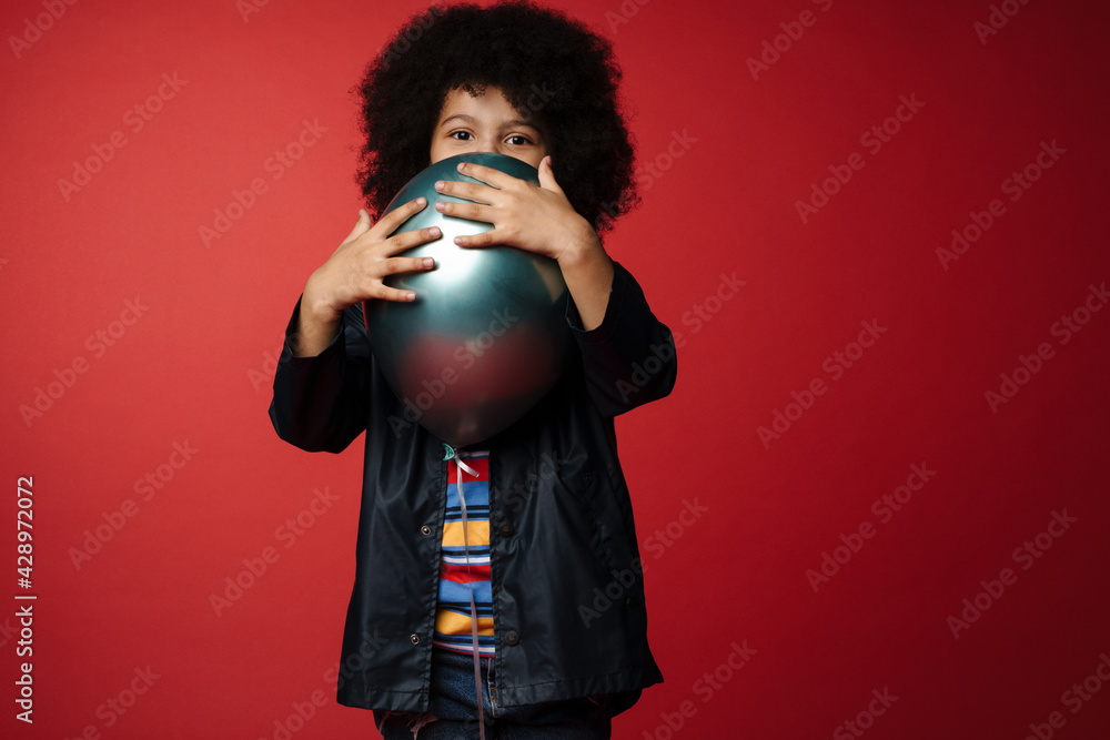 Obraz premium Happy preschooler african boy wearing coat standing