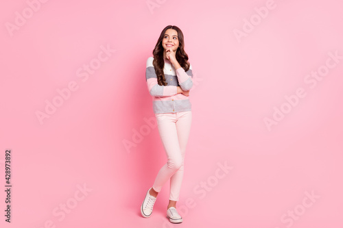 Full size photo of young lovely smiling dreamy girl looking copyspace thinking isolated on pink color background