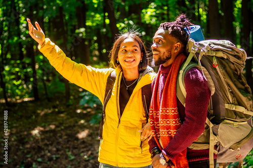 afro american mixed race couple establishing installation a tent and having a rest time outdoors