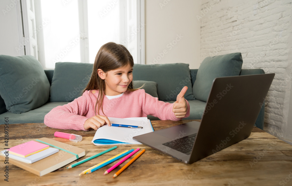School girl with laptop studying online at home as school is closed due to new COVID-19 Lockdown School girl with laptop studying online at home as school is closed due to new COVID-19 Lockdown