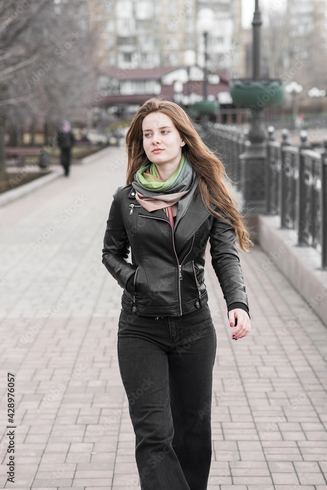 Portrait of a young girl who poses while walking in cloudy weather Portrait of a young girl who poses while walking in cloudy weather