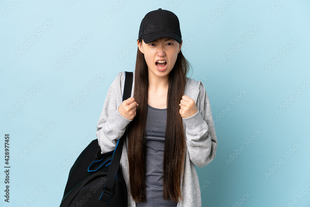 Young sport Chinese woman with sport bag over isolated blue background frustrated by a bad situation Young sport Chinese woman with sport bag over isolated blue background frustrated by a bad situation
