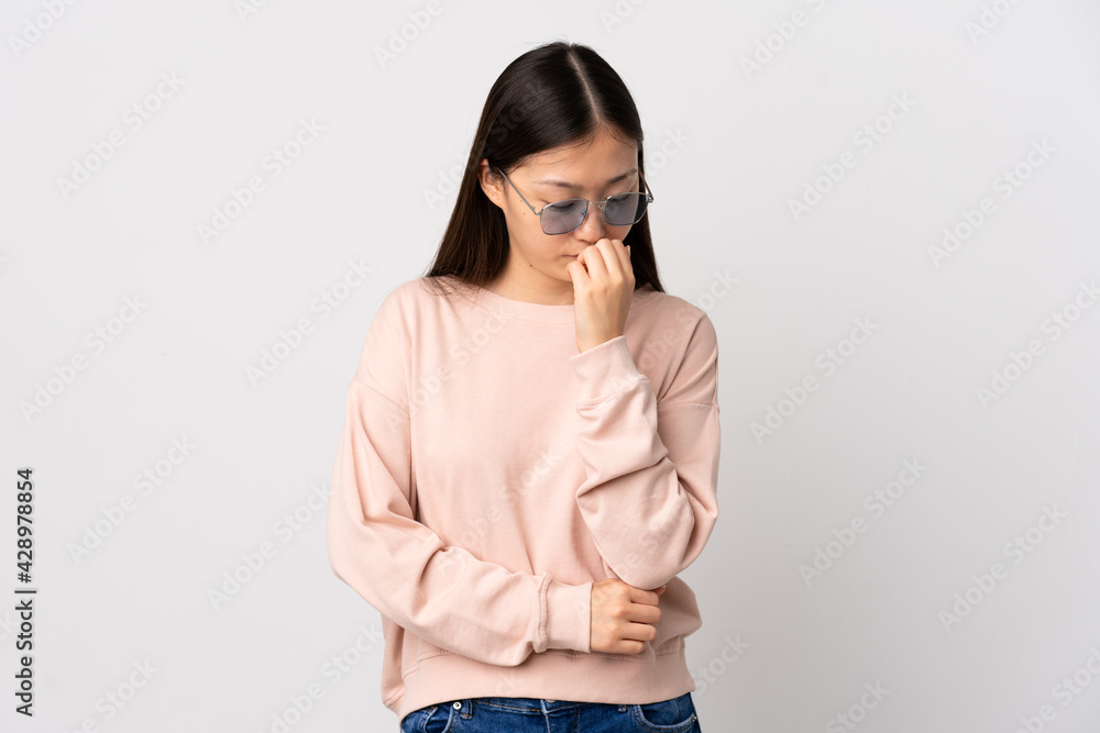 Young Chinese girl over isolated white background having doubts Young Chinese girl over isolated white background having doubts