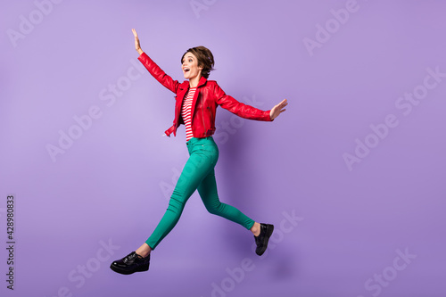 Full length profile photo of carefree person open mouth smile look empty space isolated on violet color background