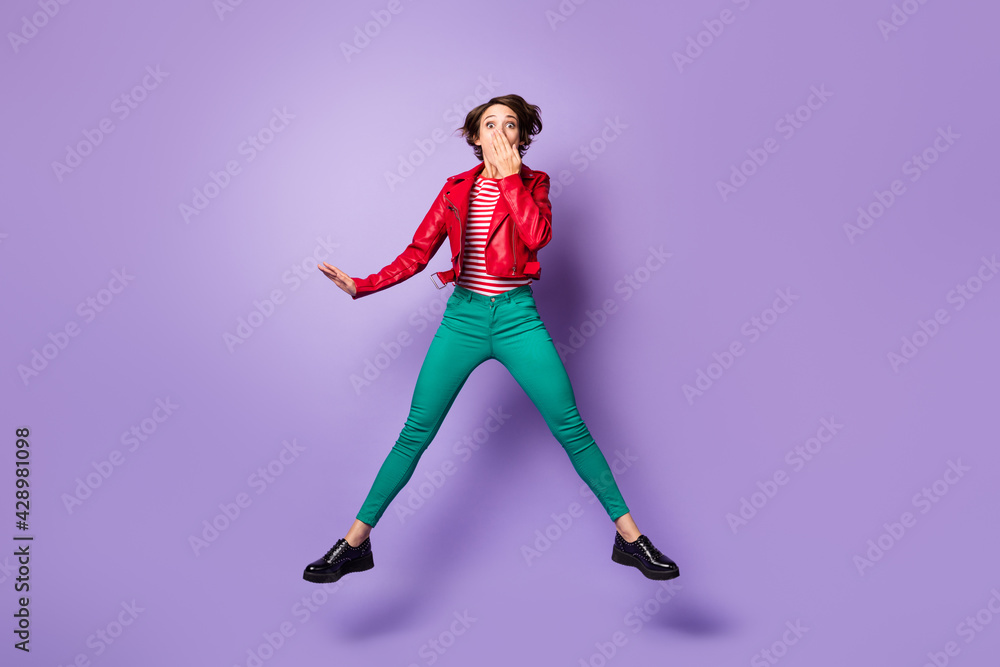 Full body photo of young woman amazed shocked surprised cover hand mouth jump isolated over purple color background