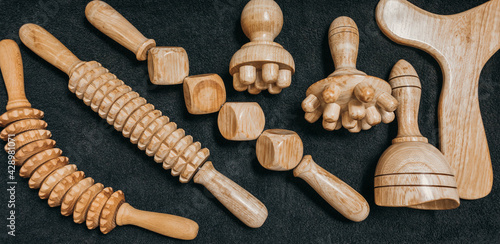 Wooden massage tools to stimulate the lymphatic system and improve circulation. Treatment to eliminate cellulite. Swedish cup, wooden roller with cubes, wooden paddle, wooden roller