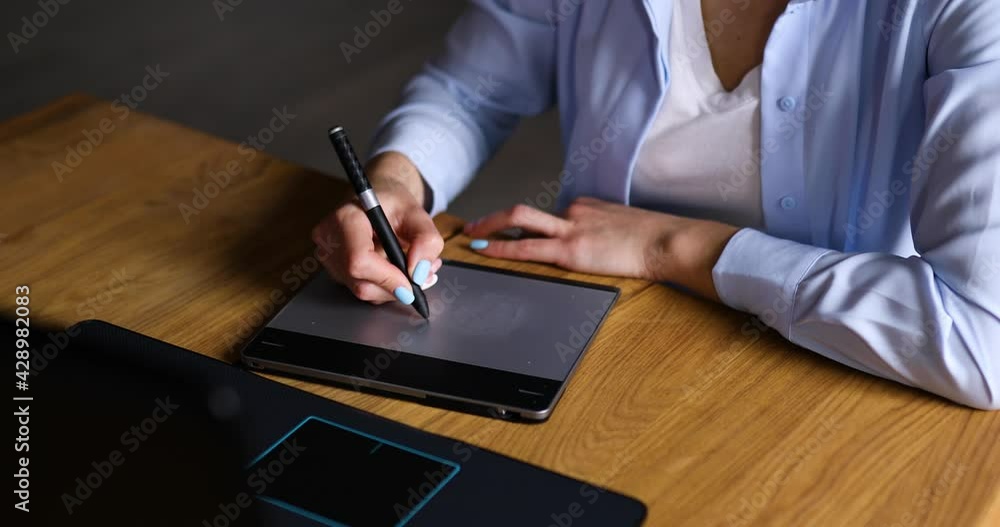 Illustrator hands scetching on tablet computer, using stylus, Creative female graphic designer draw on graphic table, working on creative project at home, Concept of modern art and technology. Illustrator hands scetching on tablet computer, using stylus, Creative female graphic designer draw on graphic table, working on creative project at home, Concept of modern art and technology.