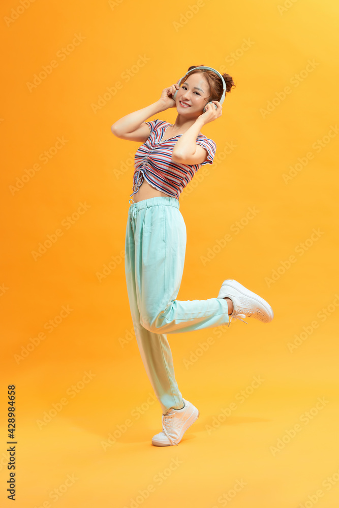 Excited lady dancing on yellow background. Excited lady dancing on yellow background.