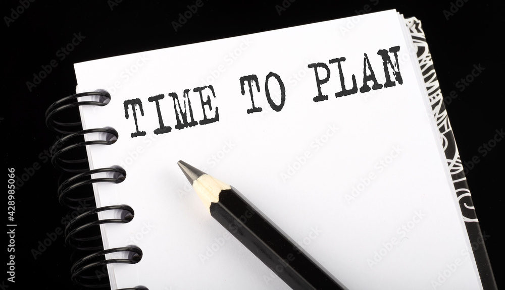 TIME TO PLAN written text in a small notebook on a black background TIME TO PLAN written text in a small notebook on a black background