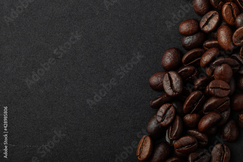 Roasted coffee beans on the black background for wallpaper or decor