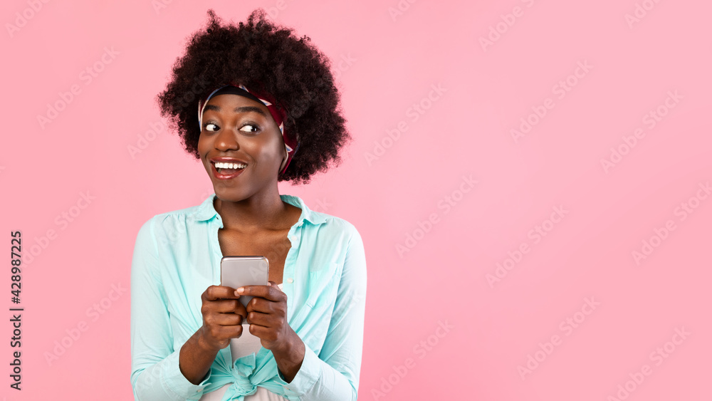Happy African American Woman Using Mobile Phone Over Pink Background Happy African American Woman Using Mobile Phone Over Pink Background