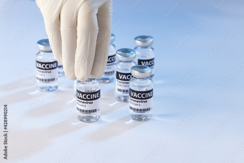 Mão pegando ampola de vacina