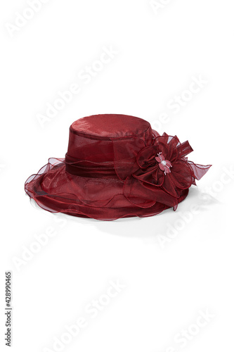 Subject shot of purple organza hat decorated with large tissue flower and pearl bead. Stylish hat for evening party is isolated on the white backdrop.
