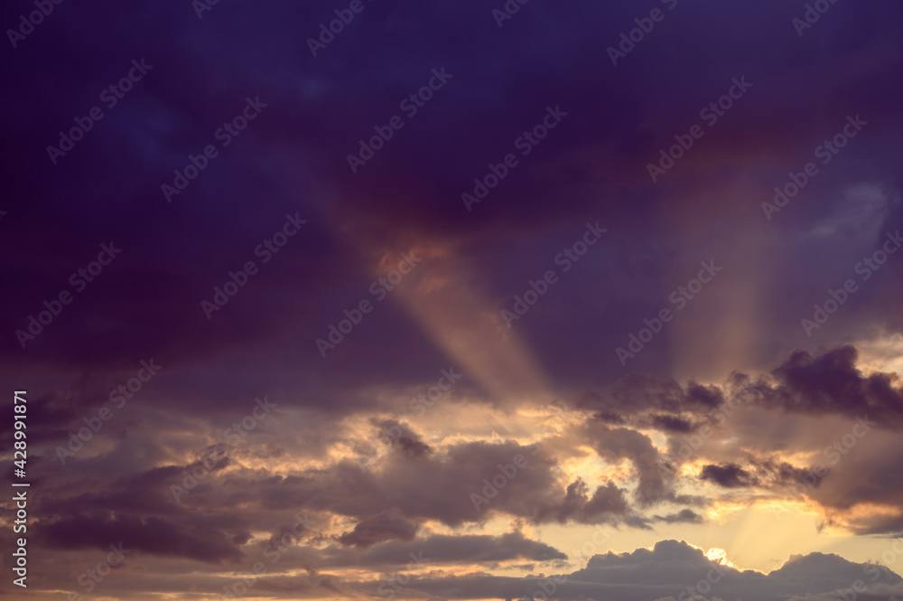 Beautiful colorful sky with clouds and sunlight. Color toned.