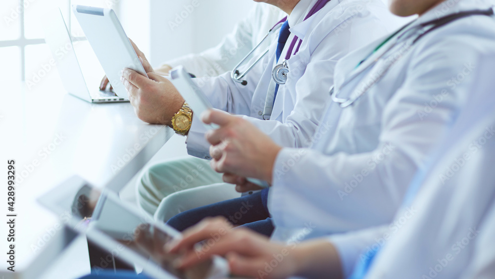 Medical team sitting and discussing at table Medical team sitting and discussing at table