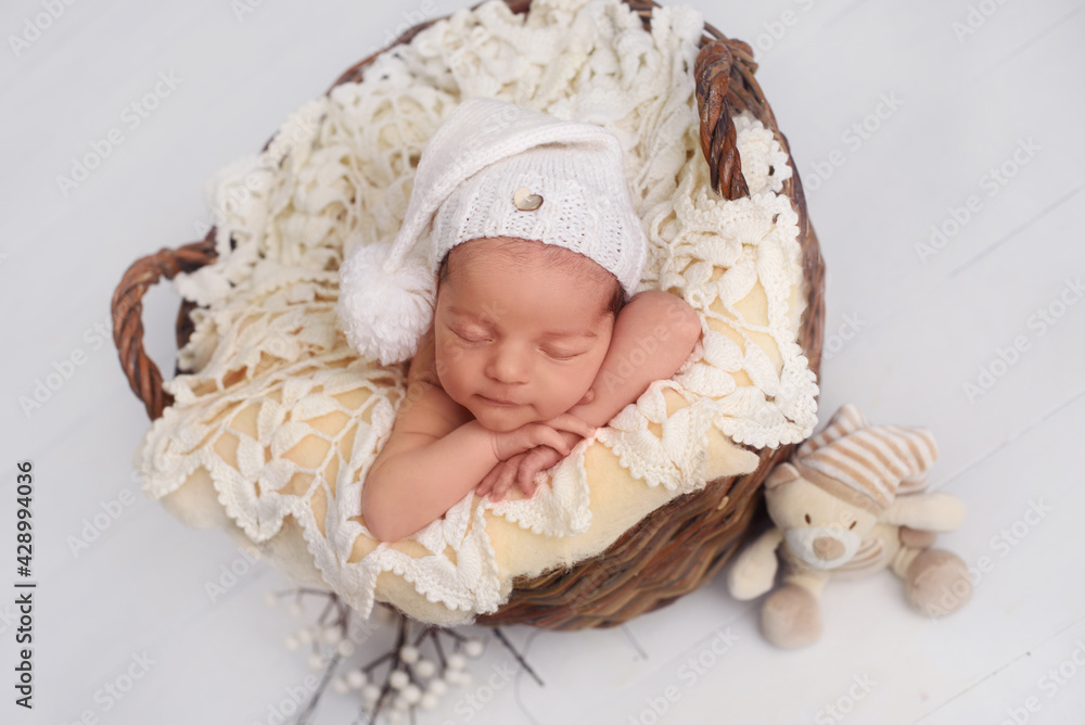 Charming newborn in cute hat sleeping. First day of life Charming newborn in cute hat sleeping. First day of life