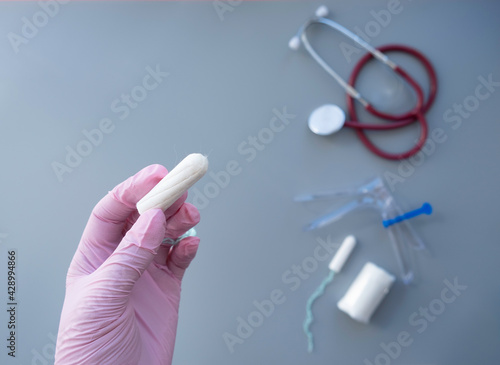 layout with medical instruments, tampons, on a gray background. photo