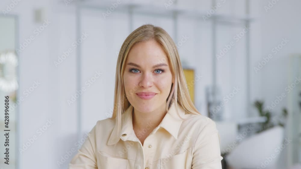 Smiling attractive young adult woman model looking at camera Smiling attractive young adult woman model looking at camera